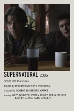 two men sitting at a table next to each other in front of a poster that says supernatural