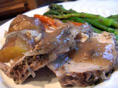 some meat and vegetables on a plate with gravy