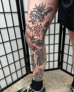 a man's legs with tattoos on them