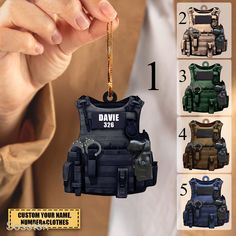 a person holding a keychain shaped like a police vest