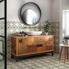 a bathroom with a sink and mirror on the wall next to a table in front of it