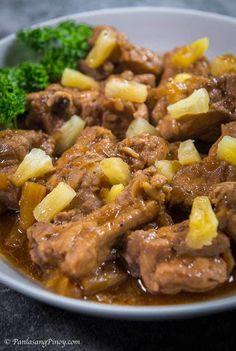 a white plate topped with meat and broccoli