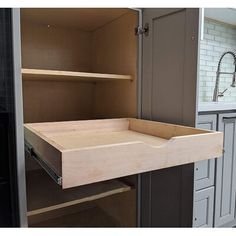 an open cabinet door in a kitchen