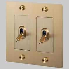 two light switch plates are shown with gold trim