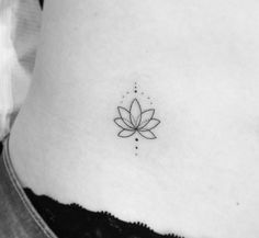 a woman's stomach with a lotus tattoo on it