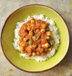 a green plate topped with rice and chickpeas