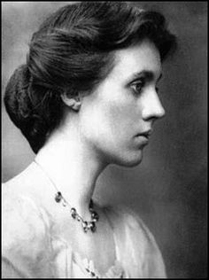 an old black and white photo of a woman with a necklace on her neck, looking to the side