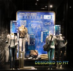 several mannequins are displayed in front of a blueprinted display case