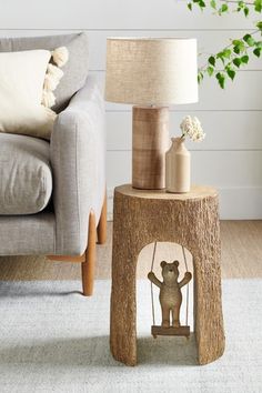 a lamp sitting on top of a wooden table next to a couch