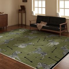 a green rug with zebras and arrows on it in the middle of a living room