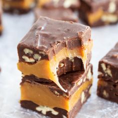 several pieces of chocolate and peanut butter fudge bars stacked on top of each other