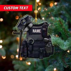 an ornament hanging from a christmas tree with the name custom text on it