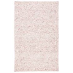 a white rug with an intricate design on the front and back side, in light pink tones