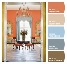 an orange and blue color scheme for a living room with chandelier, chairs, table