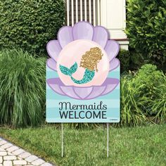 a welcome sign for a mermaid party in front of some bushes and shrubs with the words, welcome to devon's mermaid party on it