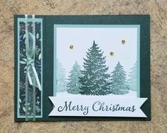 a christmas card with a pine tree and ribbon on the front, which reads merry christmas