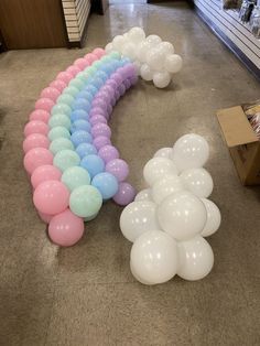 balloons are arranged in the shape of a rainbow