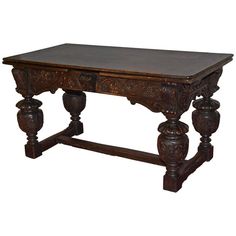 an old wooden table with carvings on the legs and top, sitting against a white background