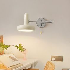 a white desk with a lamp on it and some chairs in front of the table