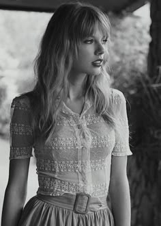 black and white photograph of a woman wearing a dress