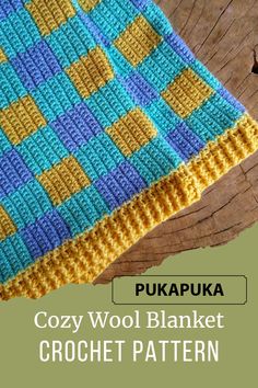 a crocheted blanket sitting on top of a wooden table with text overlay that reads cozy wool blanket crochet pattern