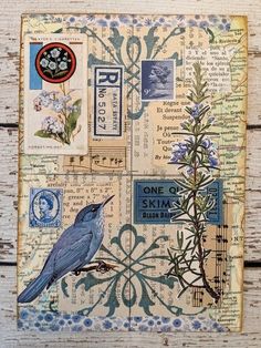 a blue bird sitting on top of a piece of paper covered in words and pictures