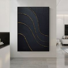 a black and gold painting in a white room