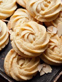 cookies with almonds are on a baking sheet