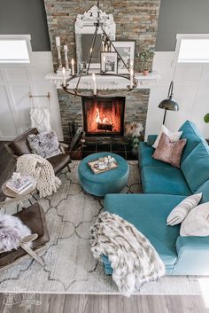 a living room filled with furniture and a fire place in the middle of the room