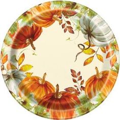 a paper plate decorated with pumpkins and leaves