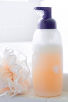 a bottle of soap sitting on top of a white counter