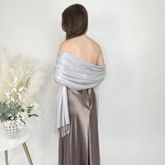 A silver pashmina scarf is versatile and will go with any bridesmaid dress and match any wedding theme. Its simply a classic and a must for winter and chilly outdoor weddings! Our wedding pashminas are extremely soft and will keep your guests warm at your wedding reception and they are great pashmina wedding favors for your guests as they are high quality. A prefect bridesmaid proposal gift is a silver bridesmaid pashmina! A pashmina scarf is also a great favor gift for guests at a bridal shower Elegant Winter Party Shawl, Elegant Gray Shawl For Winter, Elegant Silver Shawl For Evening, Formal Elegant Pashmina Shawl, Elegant Formal Pashmina Scarves, Elegant Silver Shawl For Formal Occasions, Elegant Winter Wrap Scarf, Elegant Pashmina Shawl For Wedding, Winter Wedding Pashmina Shawl