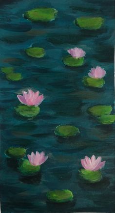 some pink water lilies floating on top of green leaves in the water with dark blue background