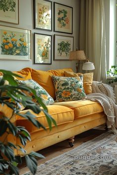 a living room with yellow couches and pictures on the wall above them, along with plants