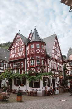 the building has many windows and plants growing on it