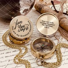 two personalized pocket watches sitting on top of an old paper with the words i love you more