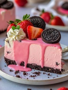 a slice of ice cream cake on a plate with strawberries and oreo cookies