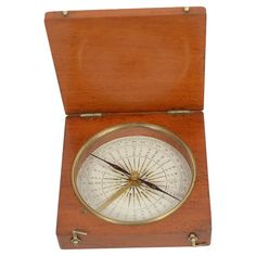 an old wooden box with a compass in it