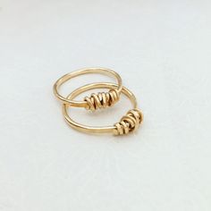 "A beautiful wire wrapped 14k gold filled ring. This delicate handmade gold filled ring with a special wire wrap texture at the top has a chic and sophisticated look. This ring looks great as a minimalist single piece, but will look even better when layered with other rings. This ring is made from high quality 14K \"Gold Filled\" - unlike \"gold plating\" the gold in gold filled jewelry is mechanically bonded to the base metal, and it will not wear off or turn black. This ring literally goes wit Simple 14k Gold Filled Stackable Anniversary Rings, Elegant Gold Hand Wrapped Rings, Handmade 14k Rose Gold Midi Rings, Handmade Minimalist Brass Stackable Rings, Handmade 14k Gold Stackable Rings For Anniversary, Handmade Minimalist Yellow Gold Stackable Rings, Stackable Midi Rings In Recycled Gold As Gift, Stackable Midi Rings In Recycled Gold For Gifts, Handmade Yellow Gold Minimalist Stackable Rings