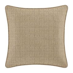 a beige pillow with brown piping on the front and back of it, against a white background