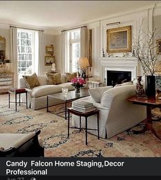 a living room filled with furniture and a fire place in the middle of a room