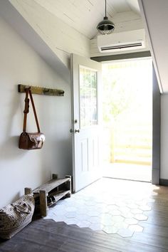 a hallway with wooden floors and white walls