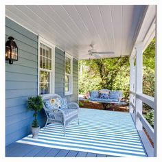 a porch with blue and white striped rugs