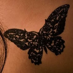 a woman's stomach with a butterfly tattoo on the side of her breast,