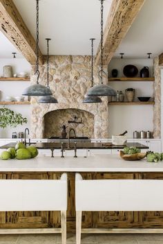 a kitchen with an oven, sink and two stools in front of the counter