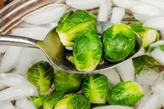 a spoon full of brussel sprouts on ice