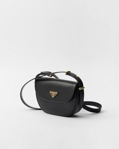 Black Prada Arqué Leather Shoulder Bag With Flap | PRADA Classic Crossbody Shoulder Bag With Logo Plaque, Modern Black Shoulder Bag With Logo Plaque, Classic Leather Shoulder Bag With Logo Plaque, Classic Crossbody Bag With Logo Plaque, Classic Shoulder Bag With Logo Plaque, Modern Formal Bag With Logo Plaque, Modern Formal Bags With Logo Plaque, Formal Black Shoulder Bag With Logo Plaque, Evening Crossbody Shoulder Bag With Logo Plaque