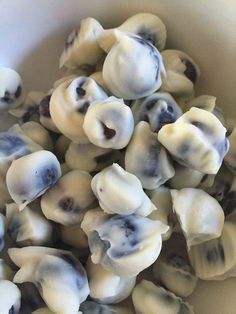 a bowl filled with lots of white and blue food