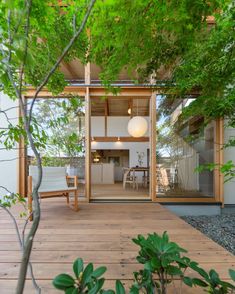 a wooden deck with chairs and tables under trees