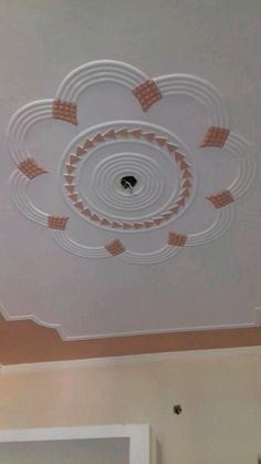 the ceiling is painted white and has orange squares on it, as well as circles in the center